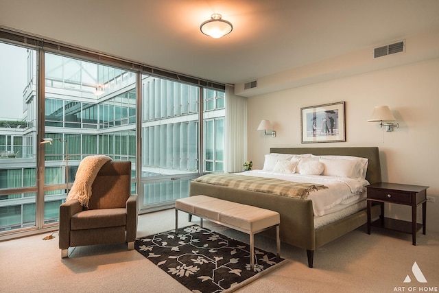 carpeted bedroom with a wall of windows, multiple windows, and visible vents