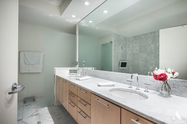 bathroom with double vanity, recessed lighting, marble finish floor, and a sink