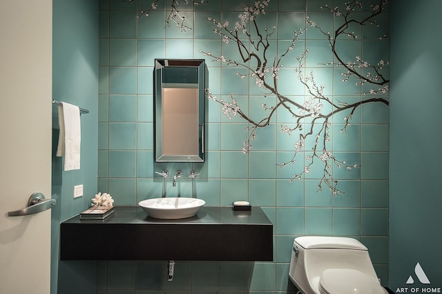 half bath featuring toilet, vanity, and tile walls