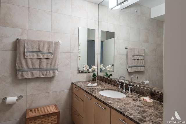 bathroom featuring tile walls and vanity