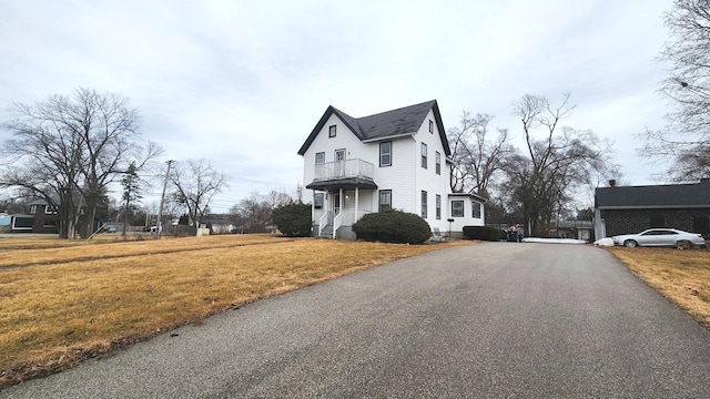 exterior space featuring driveway and a front lawn