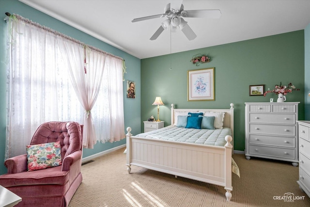 bedroom with a ceiling fan, baseboards, visible vents, and carpet flooring