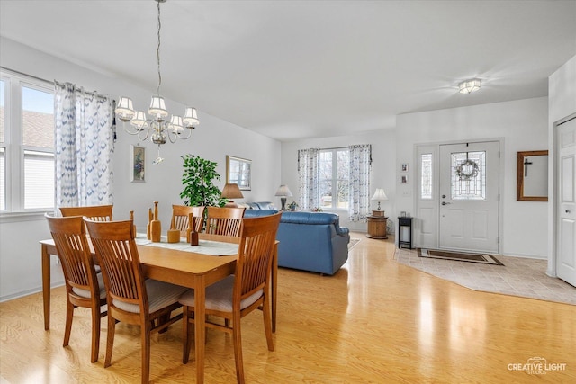 dining space featuring a chandelier and light wood-type flooring