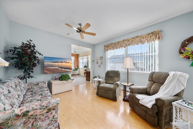 living area with a ceiling fan and wood finished floors