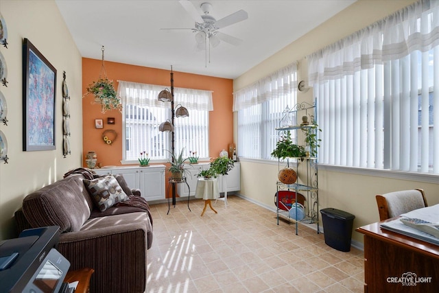 sunroom / solarium featuring a ceiling fan