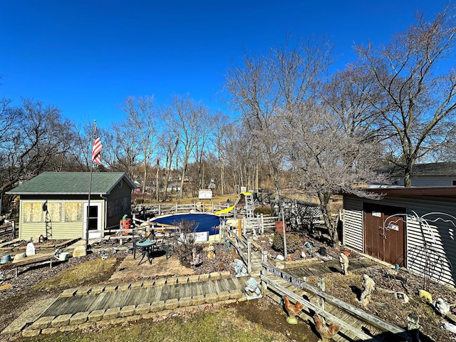 view of yard with a garden, a patio, and an outbuilding