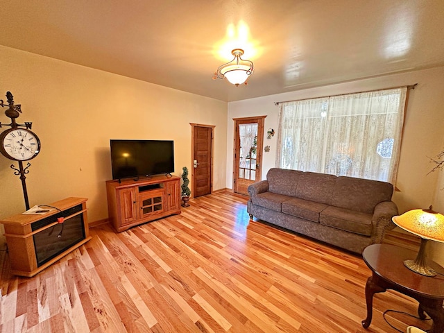 living area with light wood-style floors and baseboards