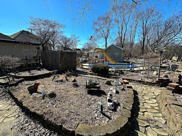 view of yard with fence and a playground