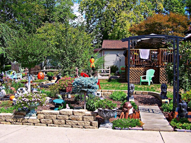 view of yard with a vegetable garden and a deck