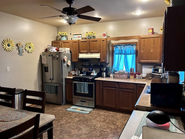 kitchen featuring ceiling fan, light countertops, appliances with stainless steel finishes, and under cabinet range hood