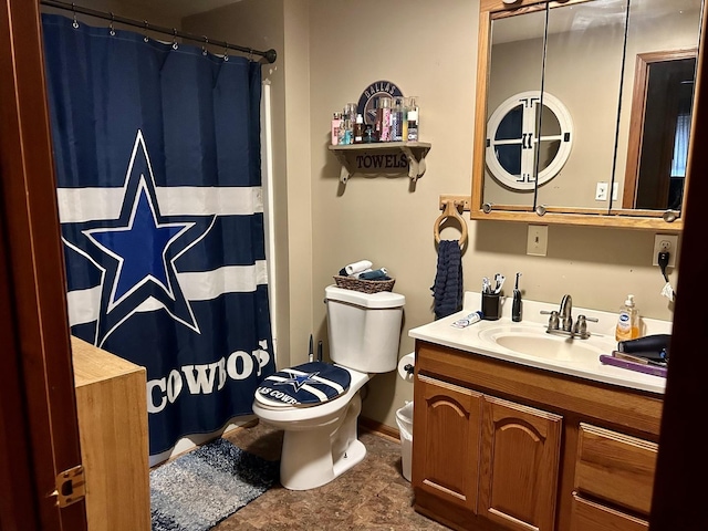 bathroom featuring toilet and vanity