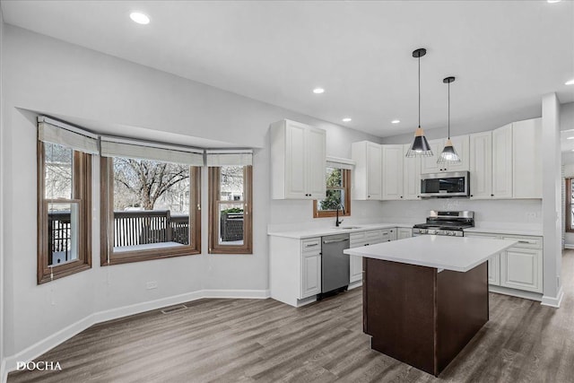 kitchen with visible vents, white cabinetry, stainless steel appliances, and light countertops