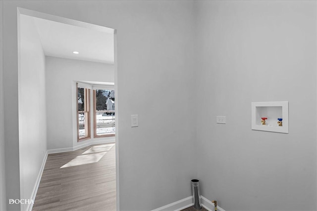 washroom featuring laundry area, baseboards, washer hookup, and wood finished floors