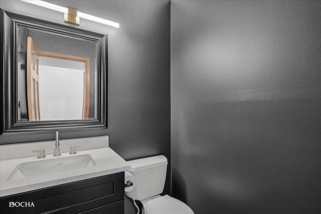 bathroom with toilet and vanity