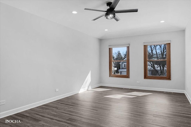 empty room featuring recessed lighting, dark wood finished floors, a ceiling fan, and baseboards