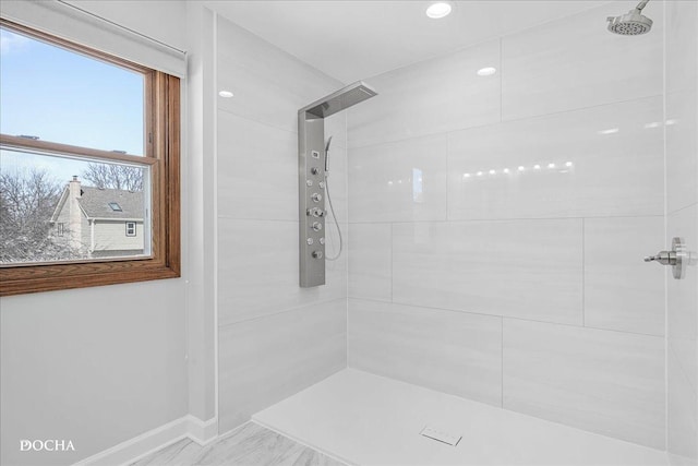 full bathroom with recessed lighting, a tile shower, and baseboards