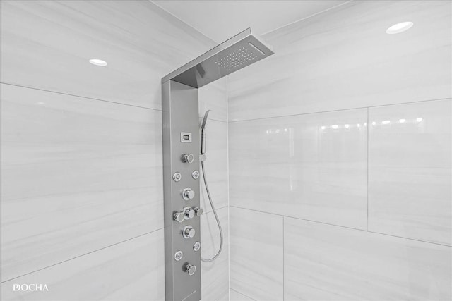 room details with tiled shower and recessed lighting