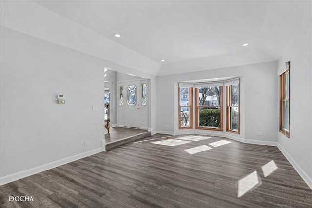 interior space with plenty of natural light, baseboards, and wood finished floors