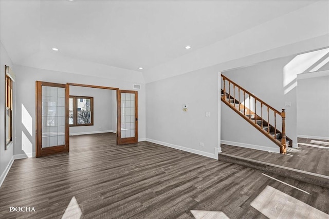 unfurnished living room with recessed lighting, dark wood finished floors, baseboards, and stairs