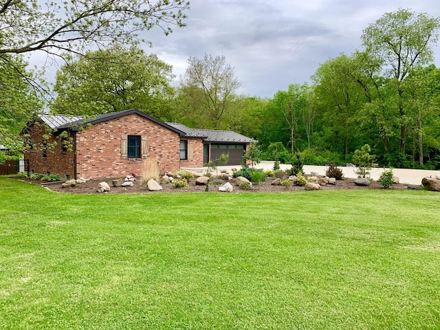 view of yard with concrete driveway and an attached garage