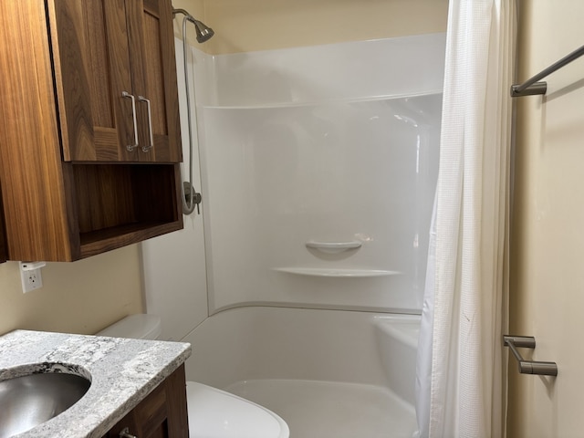 bathroom with a sink, toilet, and a shower with shower curtain