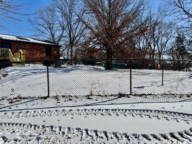 snowy yard featuring fence