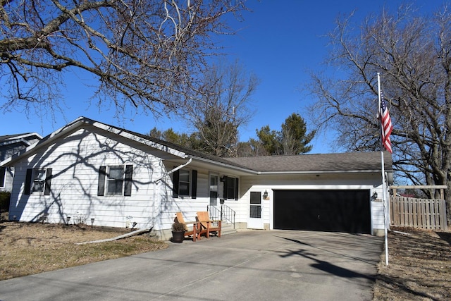 ranch-style house featuring fence, driveway, and an attached garage