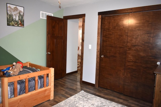 bedroom featuring baseboards, visible vents, and dark wood finished floors