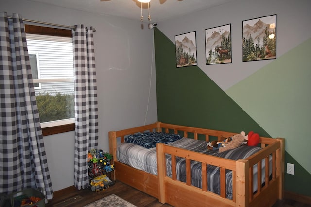 bedroom featuring a ceiling fan and wood finished floors