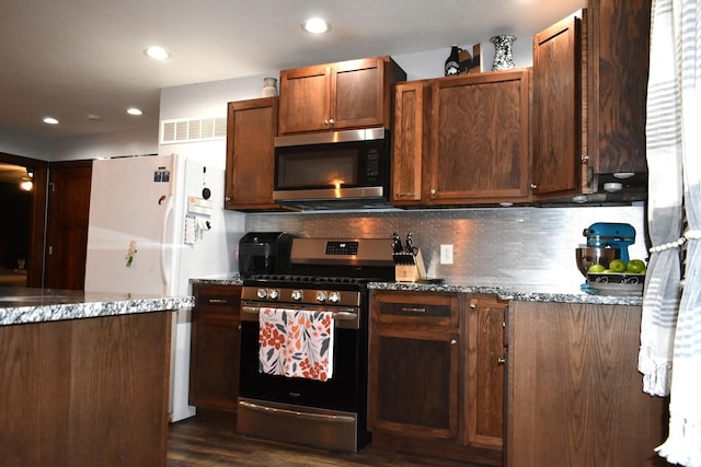 kitchen featuring tasteful backsplash, stone countertops, visible vents, appliances with stainless steel finishes, and recessed lighting