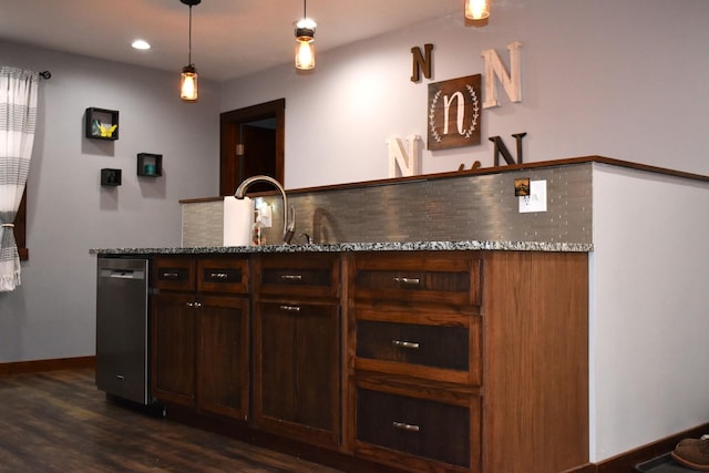 bar with a sink, hanging light fixtures, stainless steel dishwasher, tasteful backsplash, and dark wood finished floors