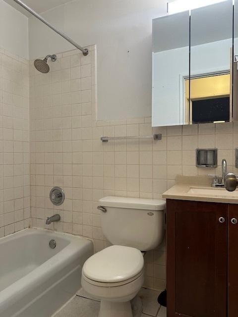 full bath featuring toilet, tile patterned flooring, tile walls, and vanity