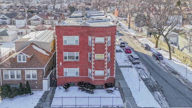 snowy aerial view with a residential view