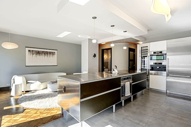 kitchen featuring stainless steel countertops, modern cabinets, built in fridge, and black electric cooktop