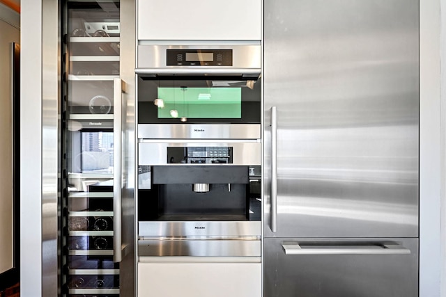 kitchen featuring beverage cooler and appliances with stainless steel finishes