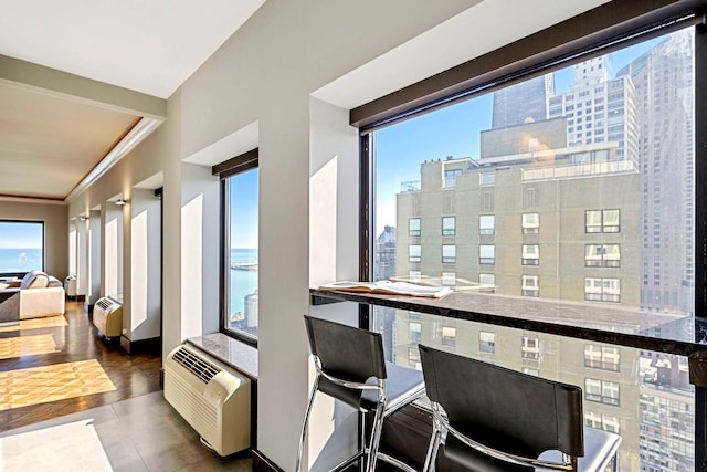 balcony with a view of city and a wall unit AC