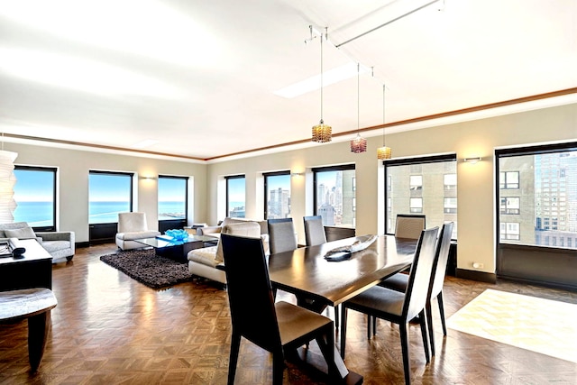 dining area with ornamental molding and baseboards