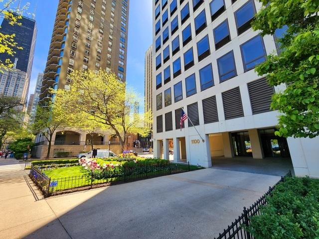 view of building exterior featuring a view of city and fence