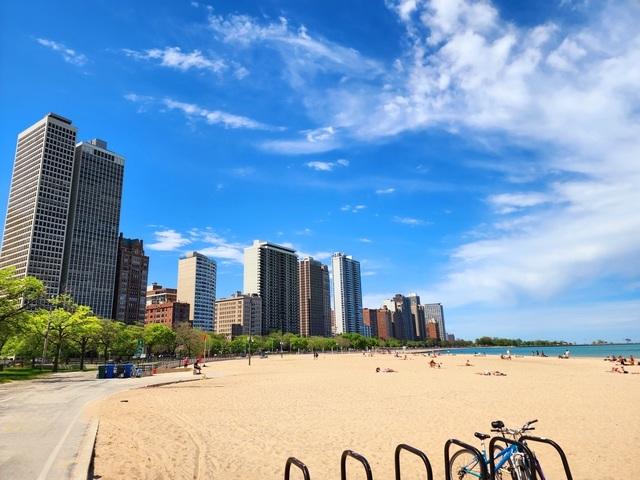 exterior space featuring a view of city, a water view, and a beach view