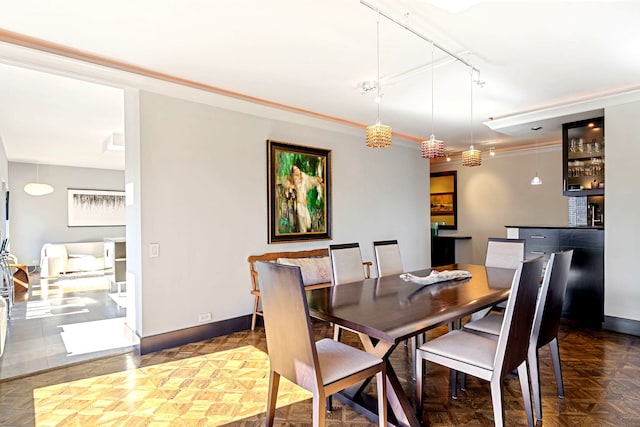 dining space with rail lighting and baseboards