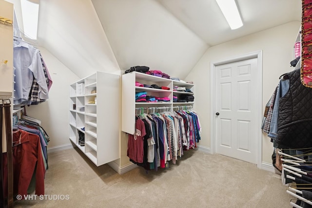 walk in closet featuring lofted ceiling and carpet flooring