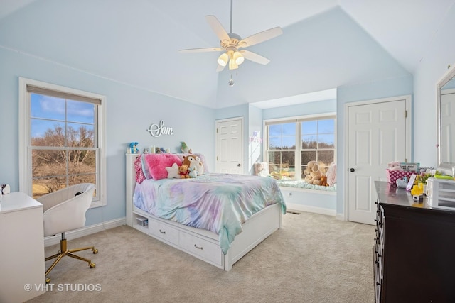 bedroom featuring light colored carpet, ceiling fan, baseboards, and vaulted ceiling