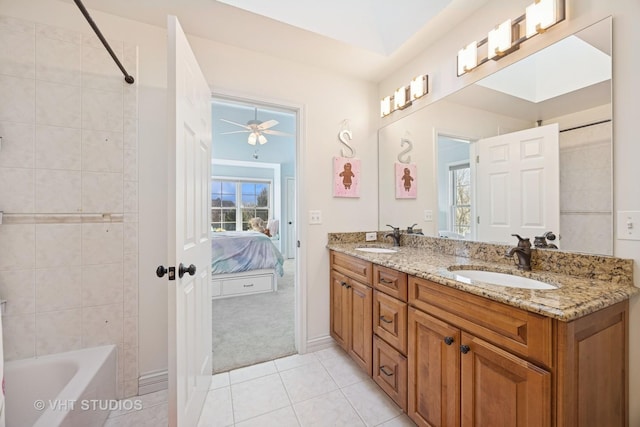 bathroom featuring a sink, connected bathroom, double vanity, and tile patterned floors