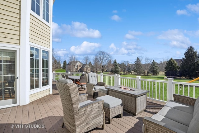 wooden deck with an outdoor living space with a fire pit