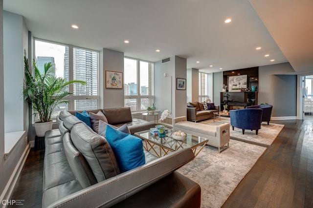 living room with visible vents, recessed lighting, baseboards, and dark wood-style flooring