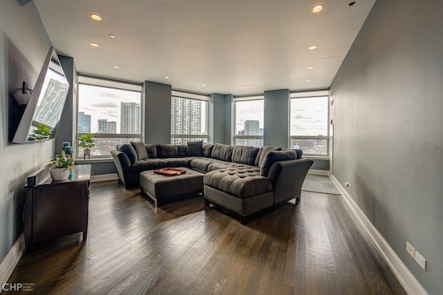 living room with recessed lighting, baseboards, and dark wood-style flooring