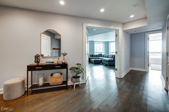 corridor with recessed lighting, wood finished floors, and baseboards