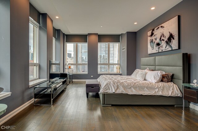 bedroom with recessed lighting, baseboards, and wood finished floors