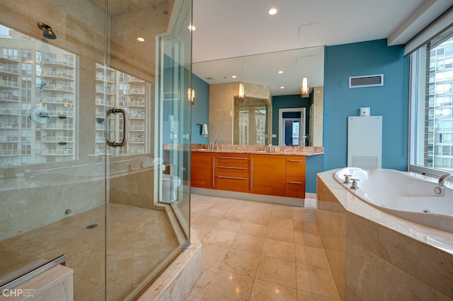 full bathroom featuring visible vents, a whirlpool tub, recessed lighting, a stall shower, and vanity