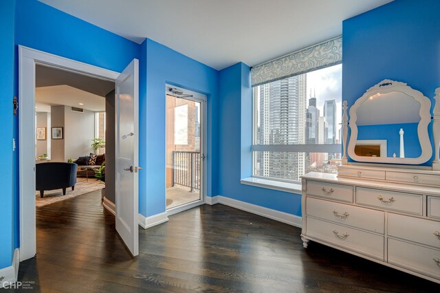 bedroom featuring access to exterior, visible vents, baseboards, and dark wood-style flooring